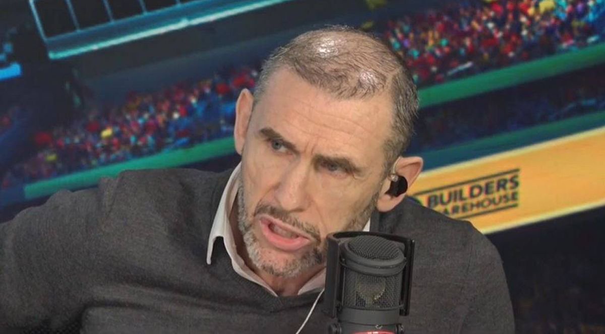 Martin Keown speaking into a microphone