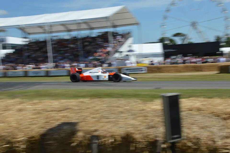 McLaren MP4/6 Formula 1 car passing a grandstand at speed