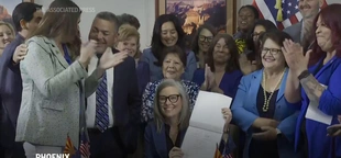 Arizona’s Democratic governor signs a bill to repeal 1864 ban on most abortions