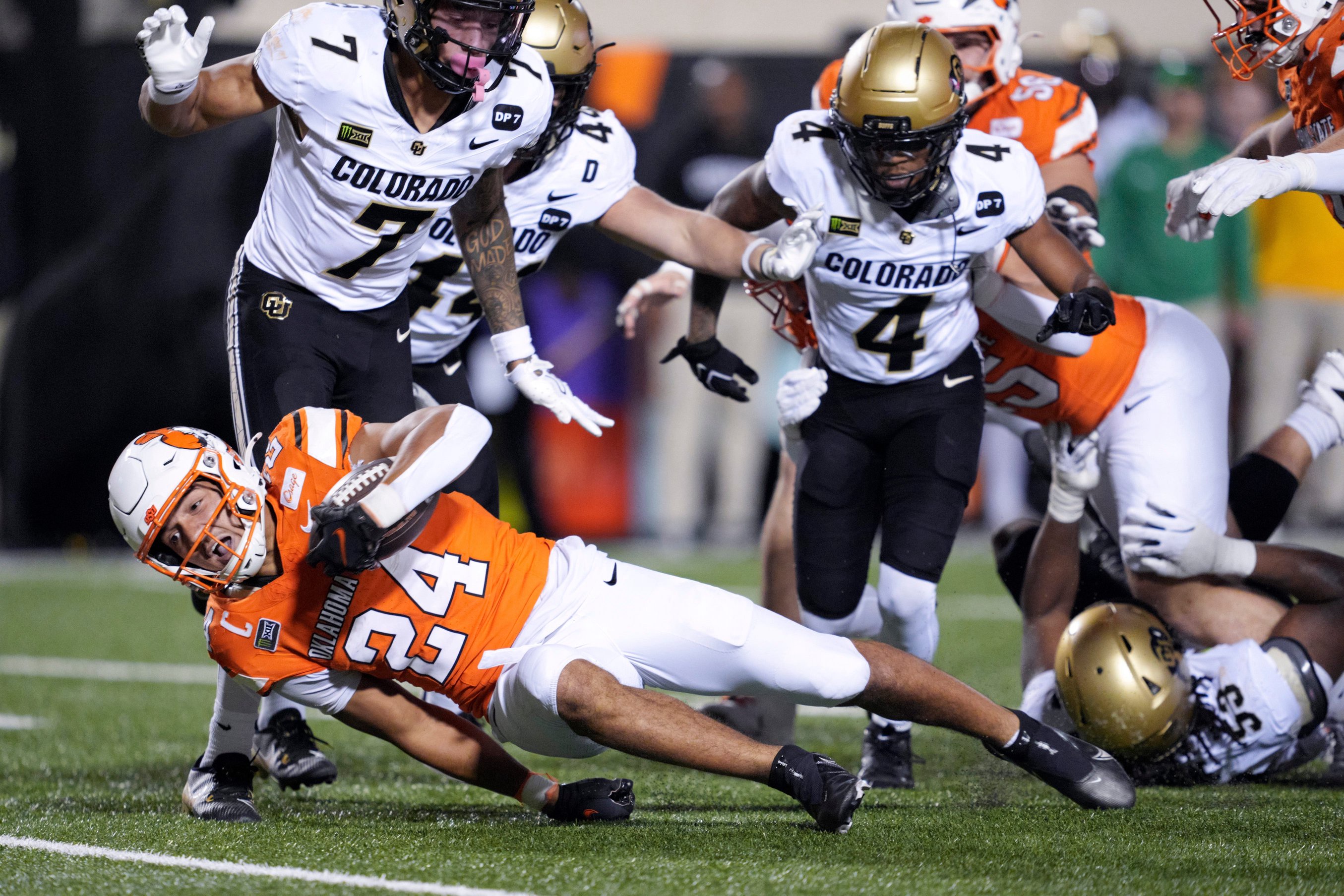 Oklahoma State Cowboys running back Caleb Hawkins (24) falls forward during a college football game between the Oklahoma State Cowboys (OSU) and the Colorado Buffaloes at Boone Pickens Stadium in Stillwater, Okla., Saturday, Oct. 24, 2026. Oklahoma State won 57-24.