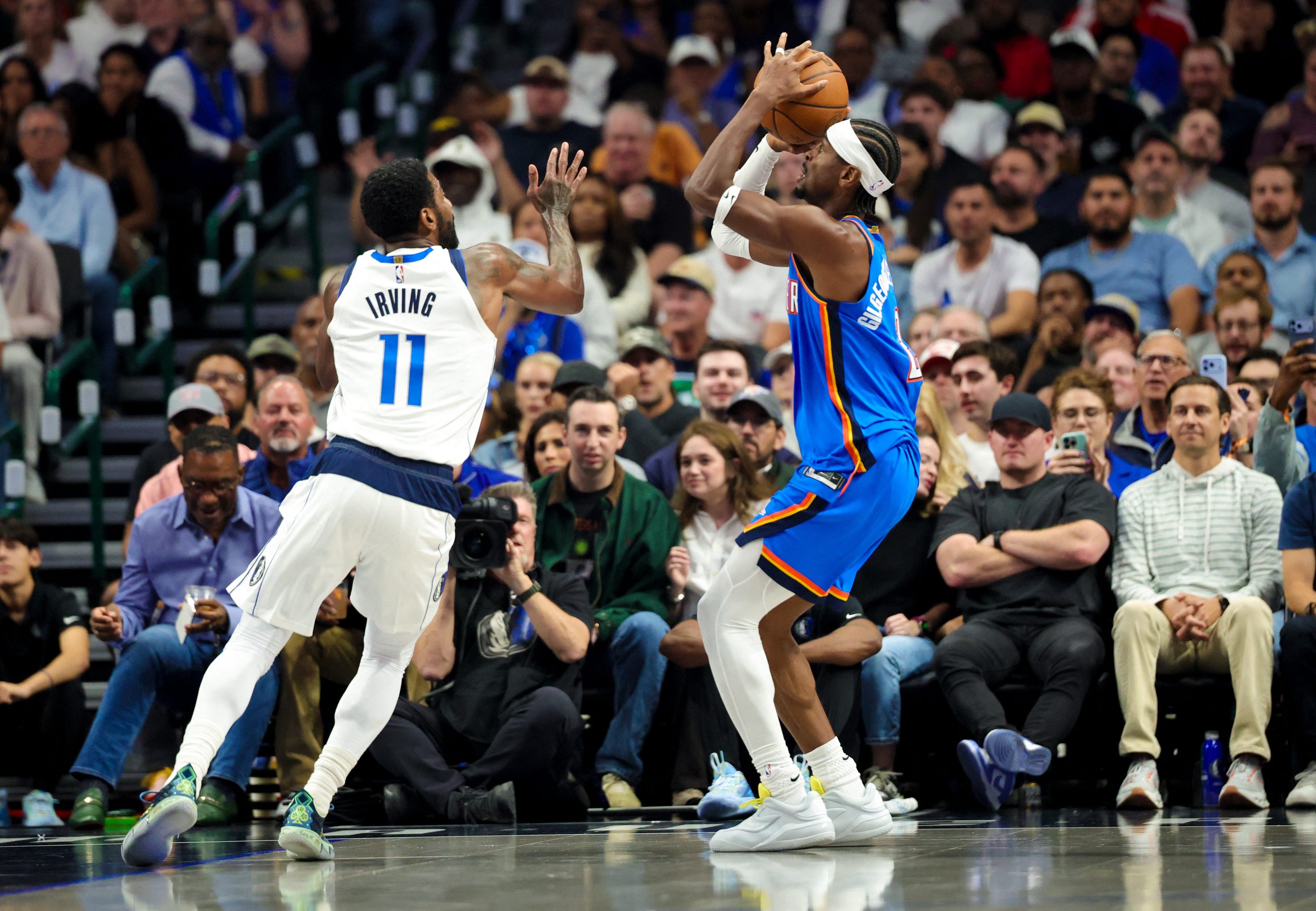 Oct 28, 2026; Dallas, Texas, USA;  Oklahoma City Thunder guard Shai Gilgeous-Alexander (2) shoots as Dallas Mavericks guard Kyrie Irving (11) defends during the first quarter at American Airlines Center. Mandatory Credit: Kevin Jairaj-Imagn Images
