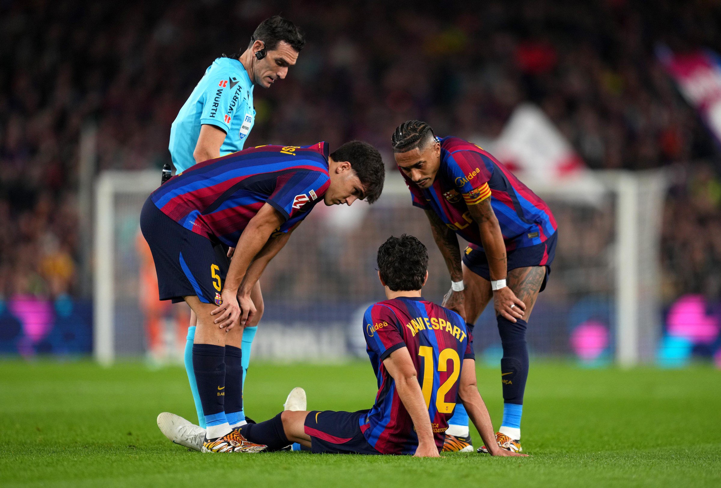 BARCELONA, SPAIN - OCTOBER 25: Xavi Espart of FC Barcelona goes down with an injury during the LaLiga EA Sports 2026/27 match between FC Barcelona and Real Madrid at Spotify Camp Nou on October 25, 2026 in Barcelona, Spain. (Photo by Alex Caparros/Getty Images)