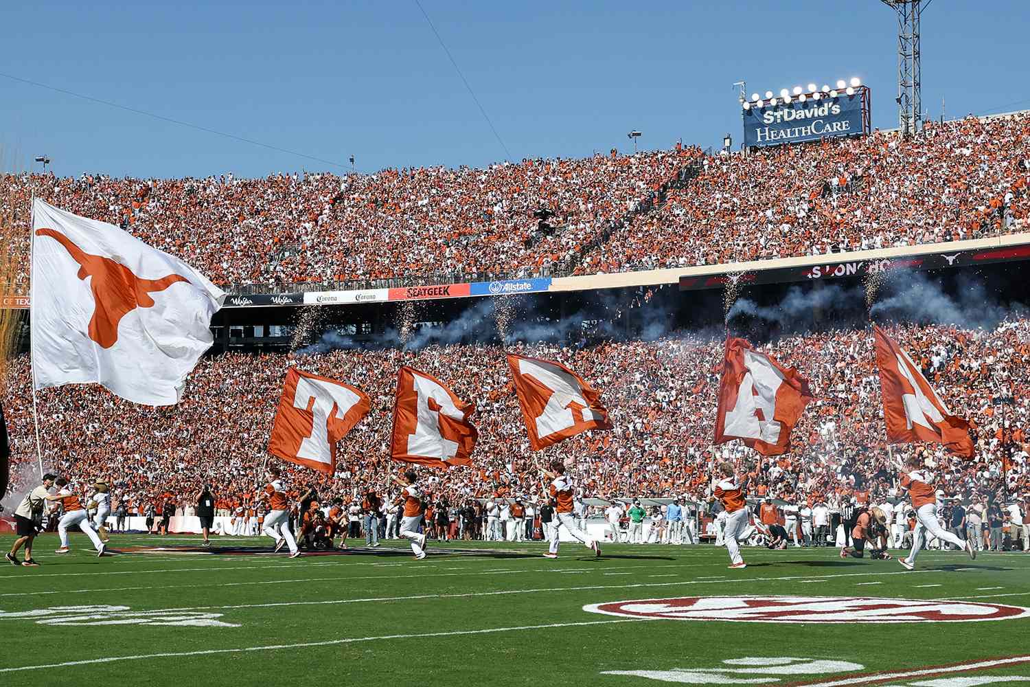 The Texas Longhorn logo and Texas flags are run onto the field at Cotton Bowl Stadium in DallasCredit: David Buono/Icon Sportswire via Getty