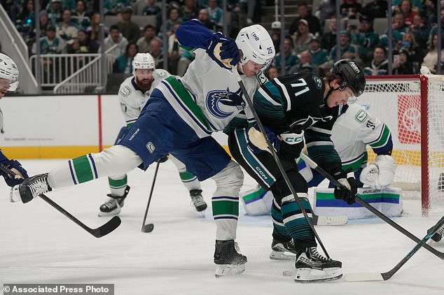 San Jose Sharks center Macklin Celebrini (71) looks for the puck against Vancouver Canucks defenseman Elias Pettersson (25) during the first period of an NHL hockey game, Thursday, Oct. 29, 2026, in San Jose, Calif. (AP Photo/Jeff Chiu)