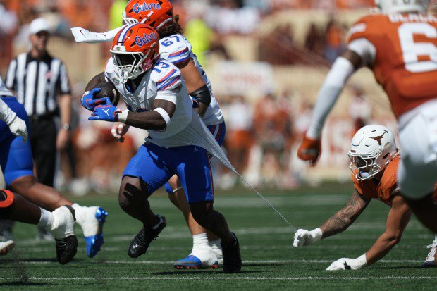 Florida running back Jadan Baugh (13) runs as a Texas defenders tears his jersey during the Gators' hard-earned 27-24 upset of the Longhorns Oct. 17 in Austin. (AP Photo/Eric Gay)