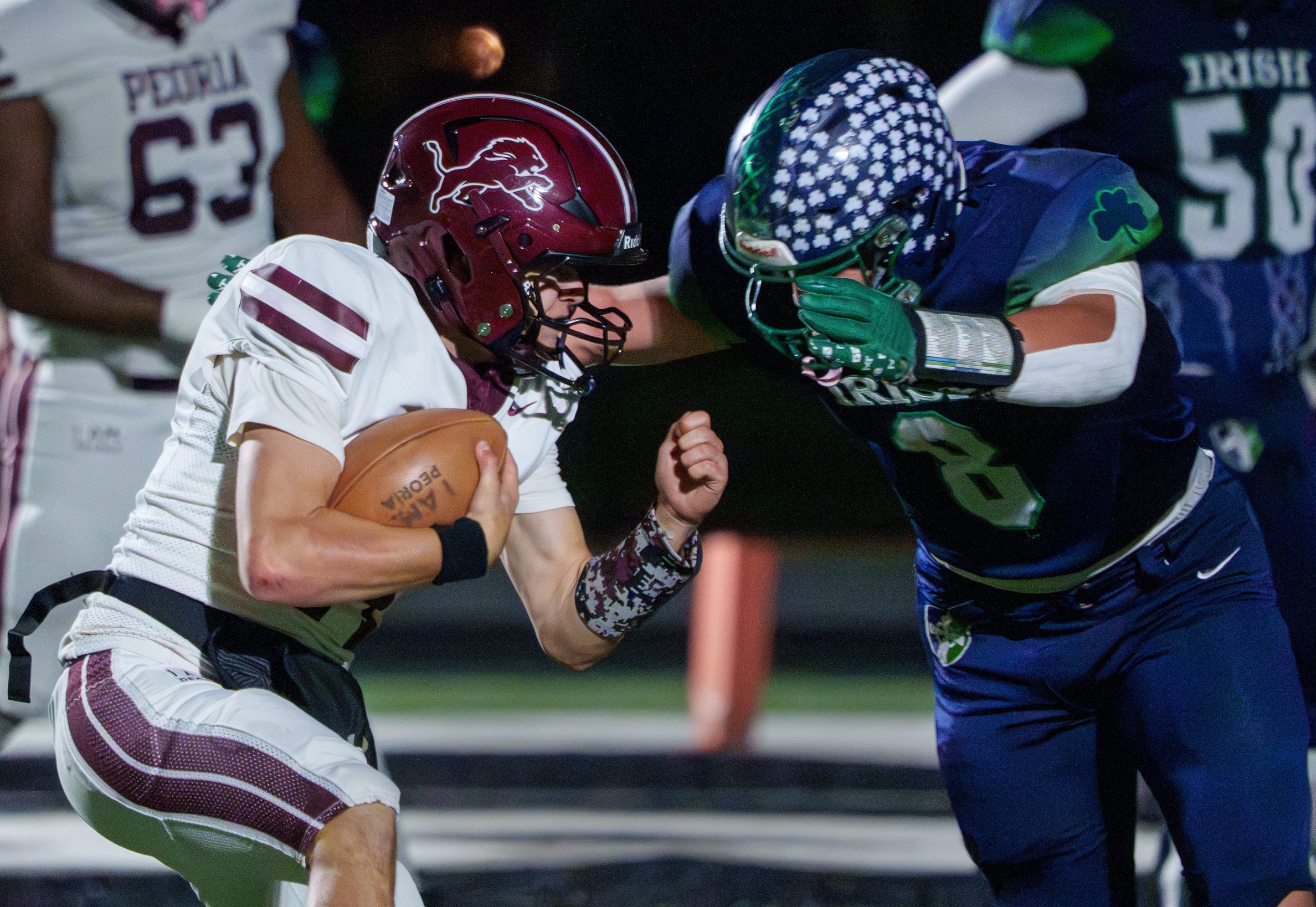 Peoria High’s Eli O’Donnell, left, runs up against Peoria Notre Dame’s Dallas Harder in the first half of their Week 9 high school football game Friday, Oct. 16, 2026 at Peoria Stadium. The Irish defeated the Lions 72-22.