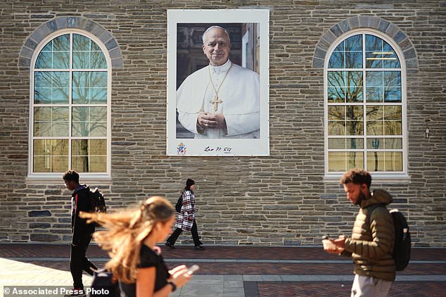 Students walk past an image of Pope Leo XIV at Villanova University in Villanova, Pa., Wednesday, Oct. 21, 2026. (AP Photo/Matt Rourke)