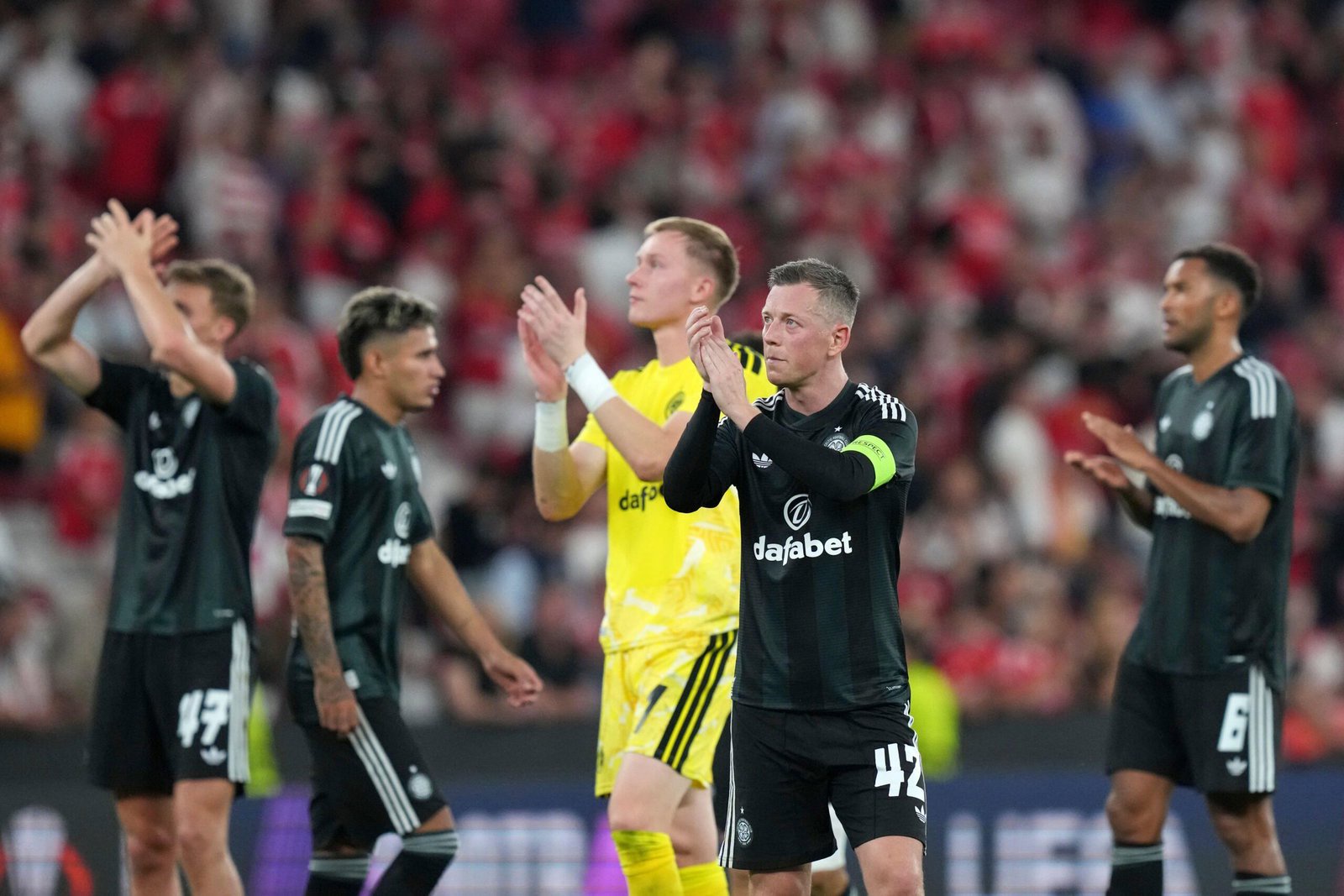 Celtic players greet their fans after the Europa League defeat to Benfica in Lisbon