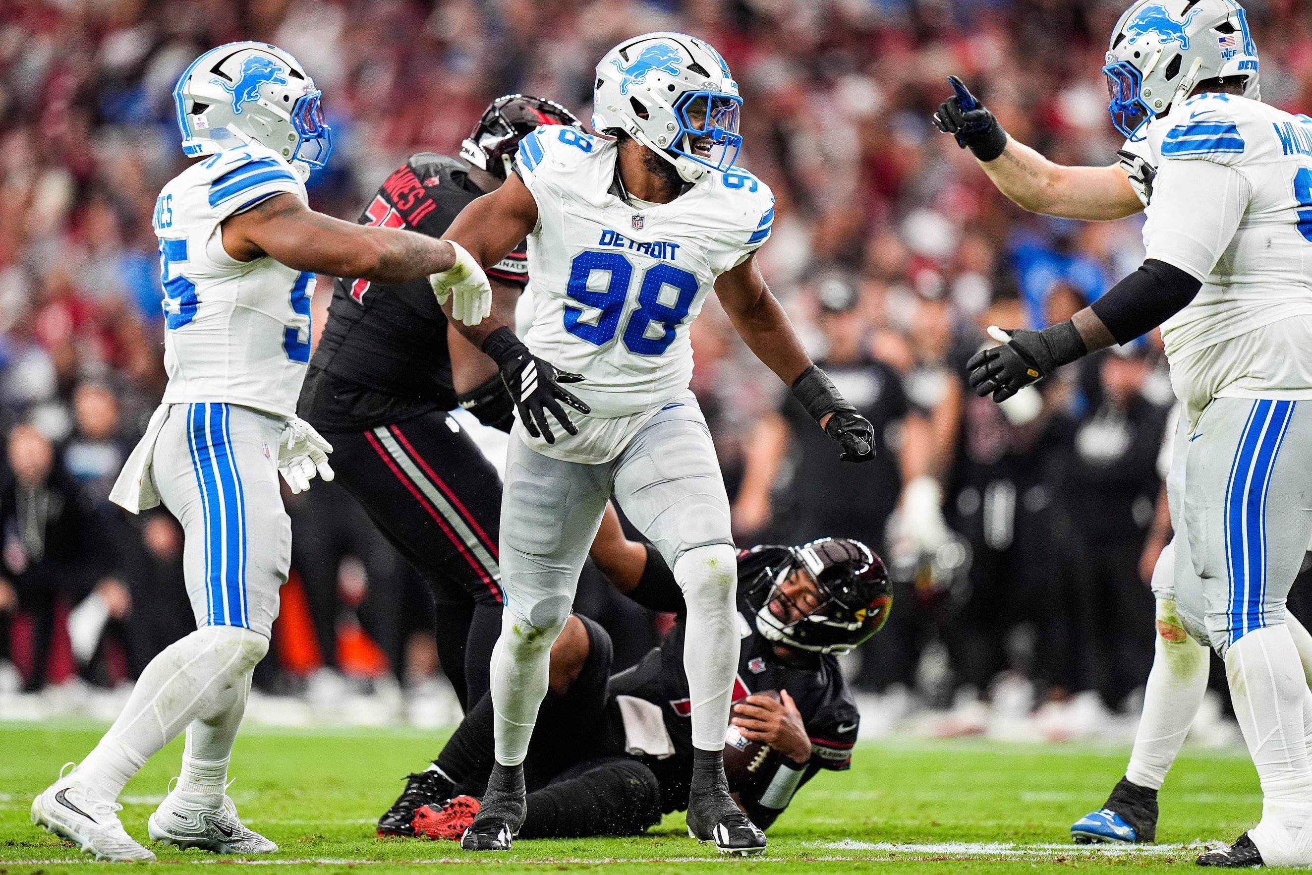 Detroit Lions edge rusher DJ Wonnum (98) celebrates a sack of Arizona Cardinals quarterback Jacoby Brissett (7) during the first half at State Farm Stadium in Glendale, Arizona, on Sunday, Oct. 11, 2026.