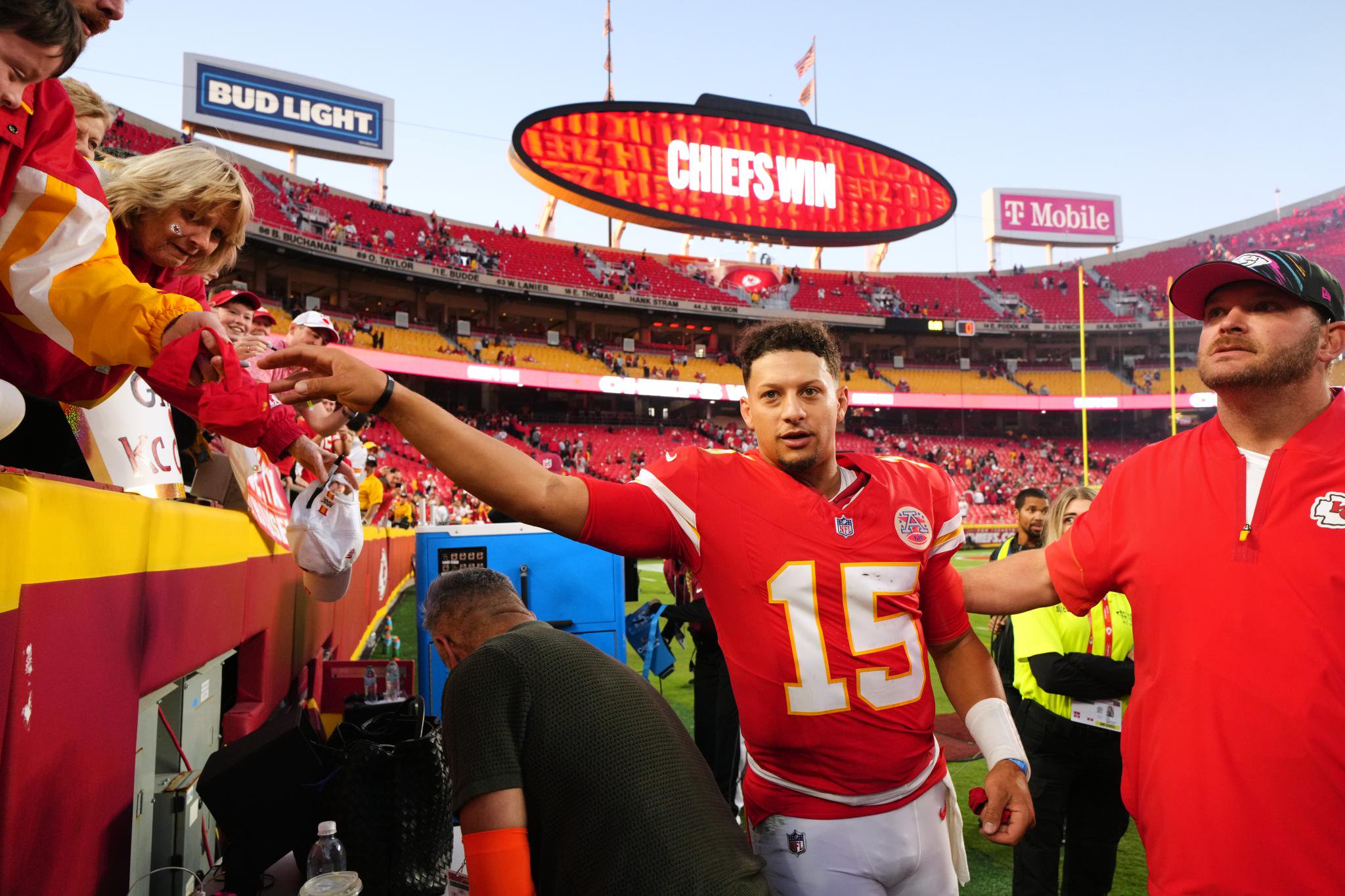 Kansas City Chiefs quarterback Patrick Mahomes (15) hands a fan a souvenir after an NFL football game against the Los Angeles Chargers in Kansas City, Mo., Sunday, Oct. 18, 2026.