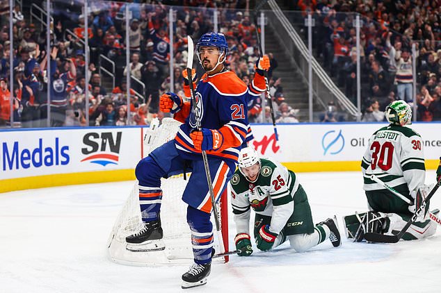 Edmonton Oilers' Mathieu Joseph (21) celebrates a goal against the Minnesota Wild during during the second period of an NHL hockey game in Edmonton, Tuesday, Oct. 20, 2026. (Codie McLachlan/The Canadian Press via AP)