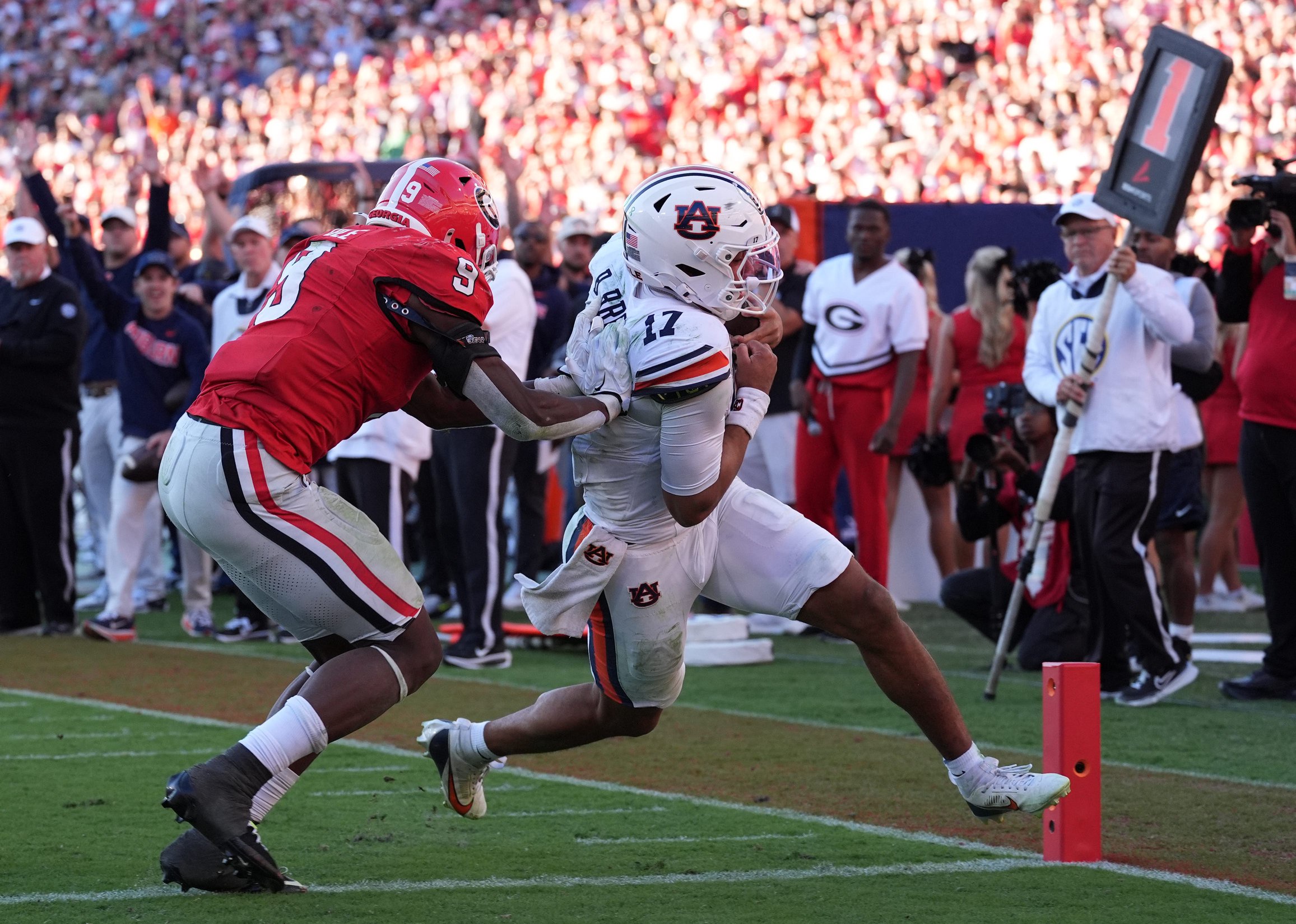 Auburn quarterback Byrum Brown (17) runs for a touchdown past Georgia linebacker Chris Cole (9) during the third quarter at Sanford Stadium. 