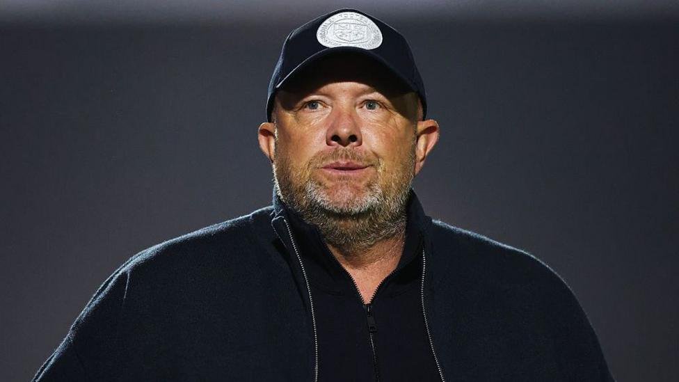 Andy Woodman, pictured in a black Bromley baseball cap