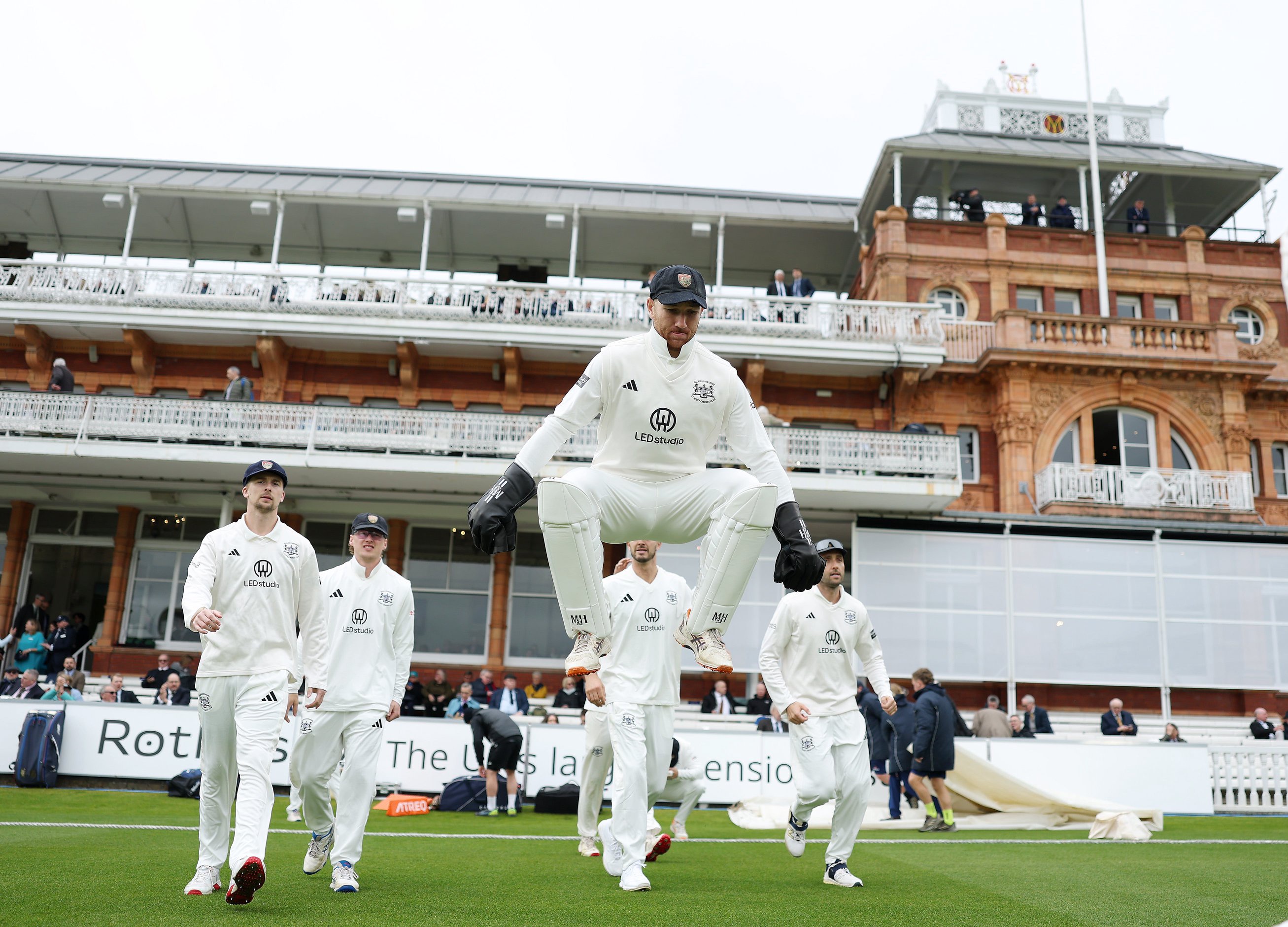 Gloucestershire wicket-keeper James Bracey takes to the field