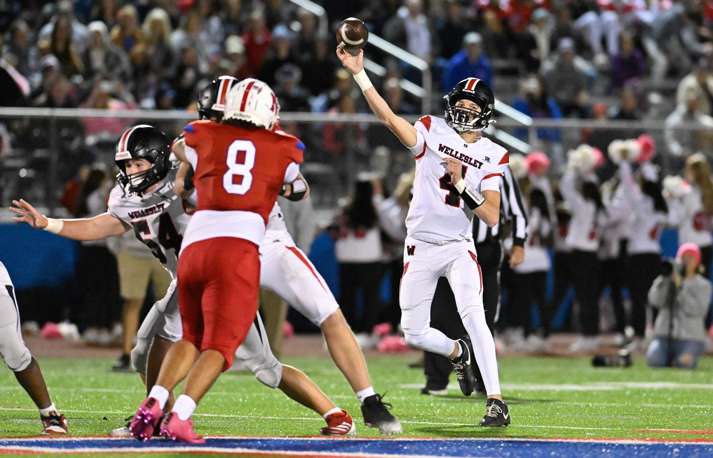 Wellesley sophomore quarterback Lukas Prock passes the ball during a football game