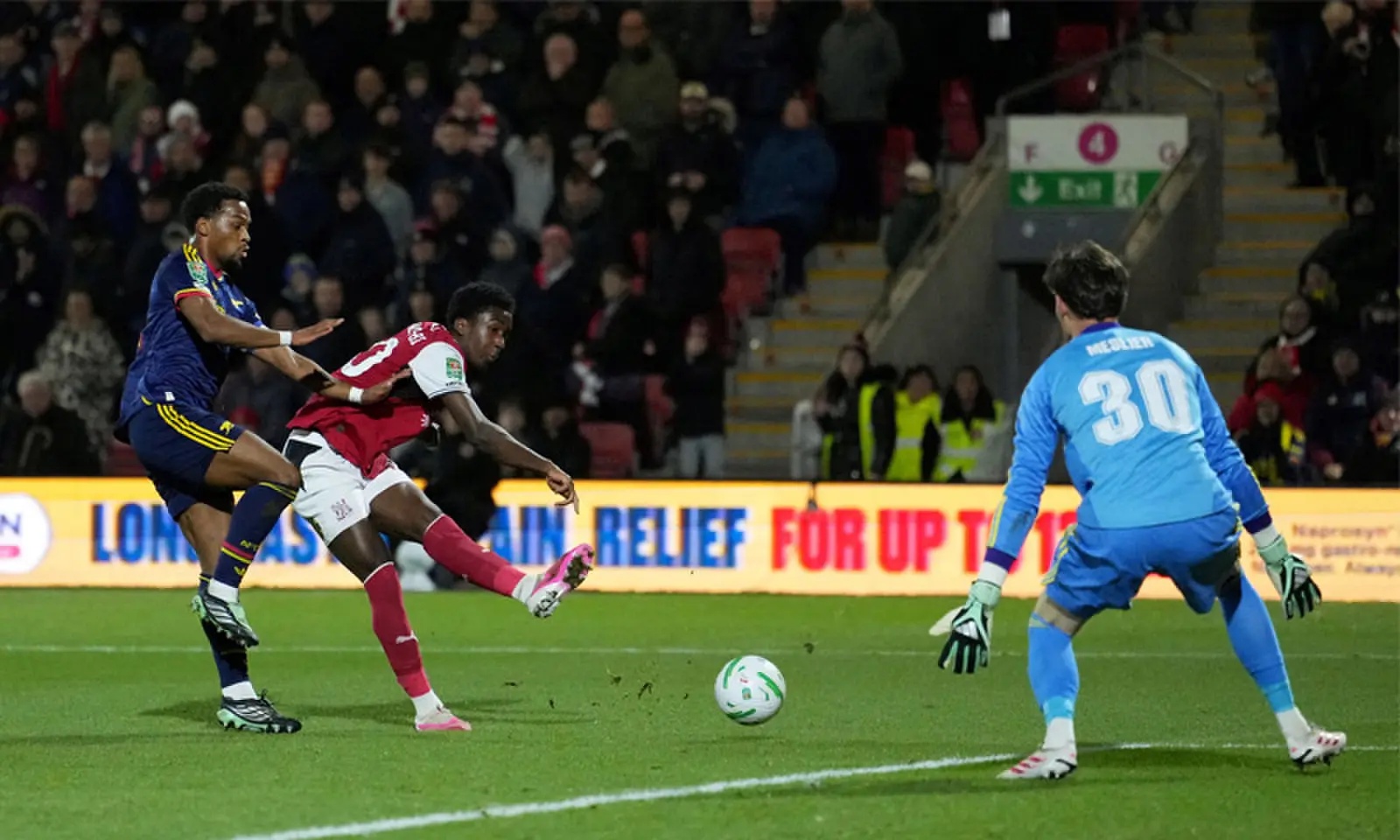 FLEETWOOD: Fleetwood Town’s Aaron Loupalo-Bi (C) scores past Arsenal goalkeeper Illan Meslier during their League Cup match at the Highbury Stadium.—Reuters