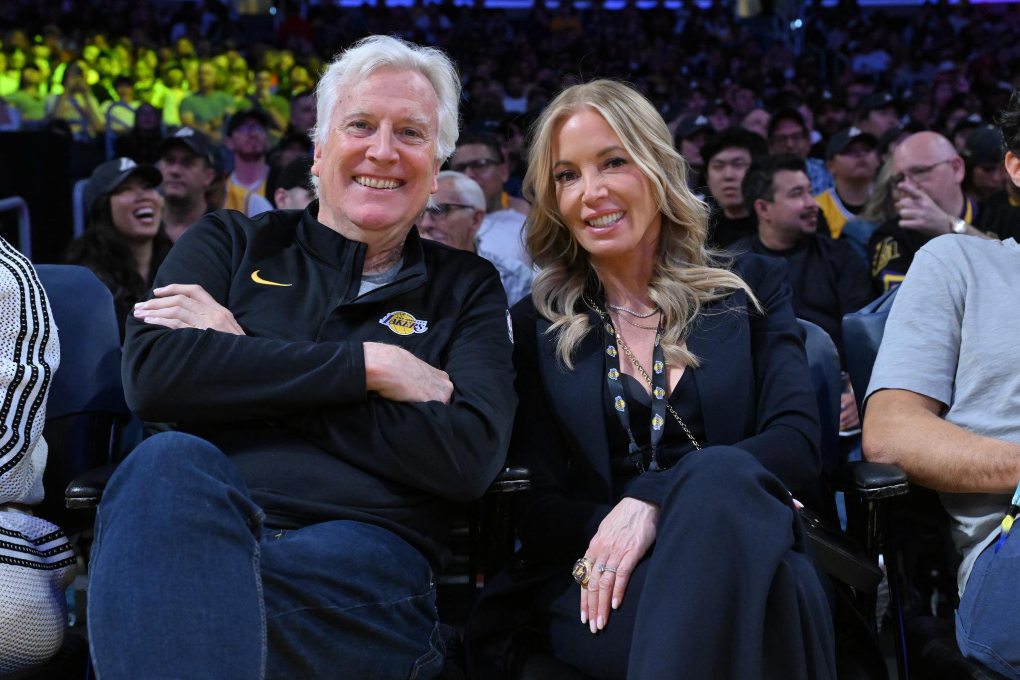 Mark Walter and Jeanie Buss sitting courtside at a basketball game.