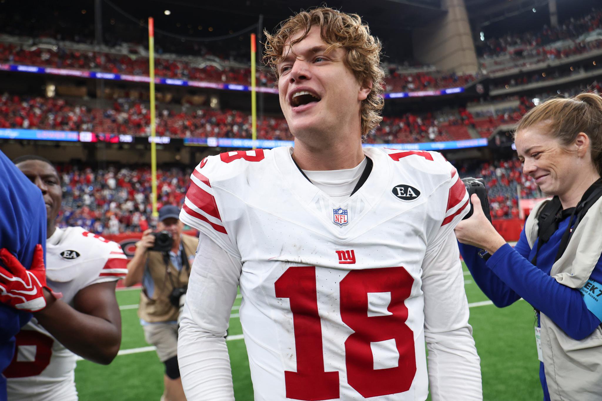 Giants quarterback J.J. McCarthy (18) smiles after the game against the Houston Texans.