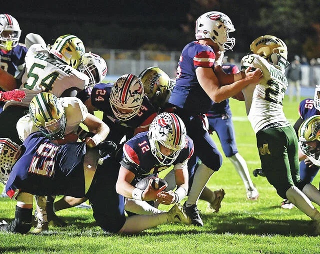 <p>Pittston Area quarterback Santino Capitano (12) squeezes his way through the Warrior defensive line to score a touchdown for the Patriots on Friday night at Trippi Stadium.</p>
                                 <p>Tony Callaio | For Times Leader</p>
