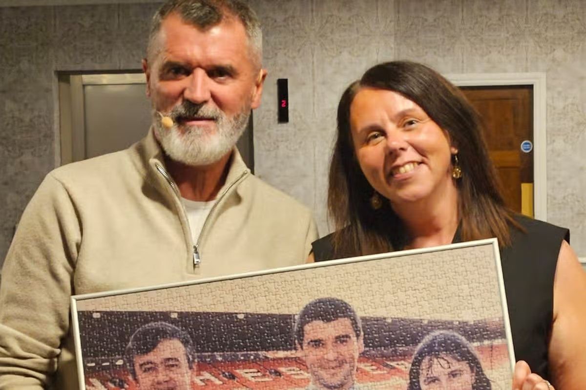 Claire and Roy holding a jigsaw of the time they met 30 years ago