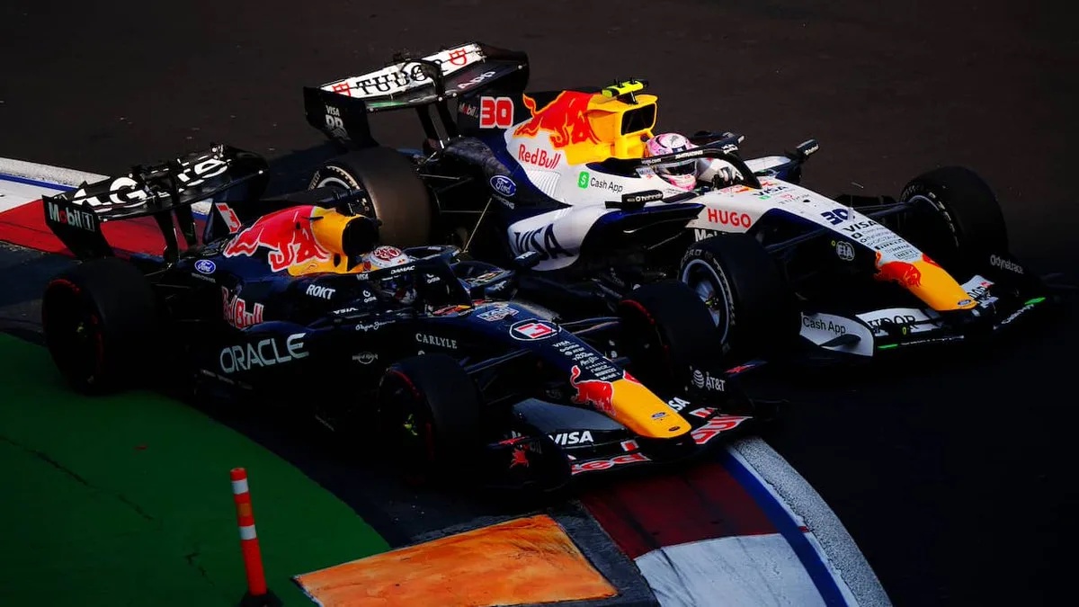 Red Bull F1 cars of Max Verstappen (1) and Liam Lawson (30) side by side on track at the Mexico City Grand Prix, near the Foro Sol section