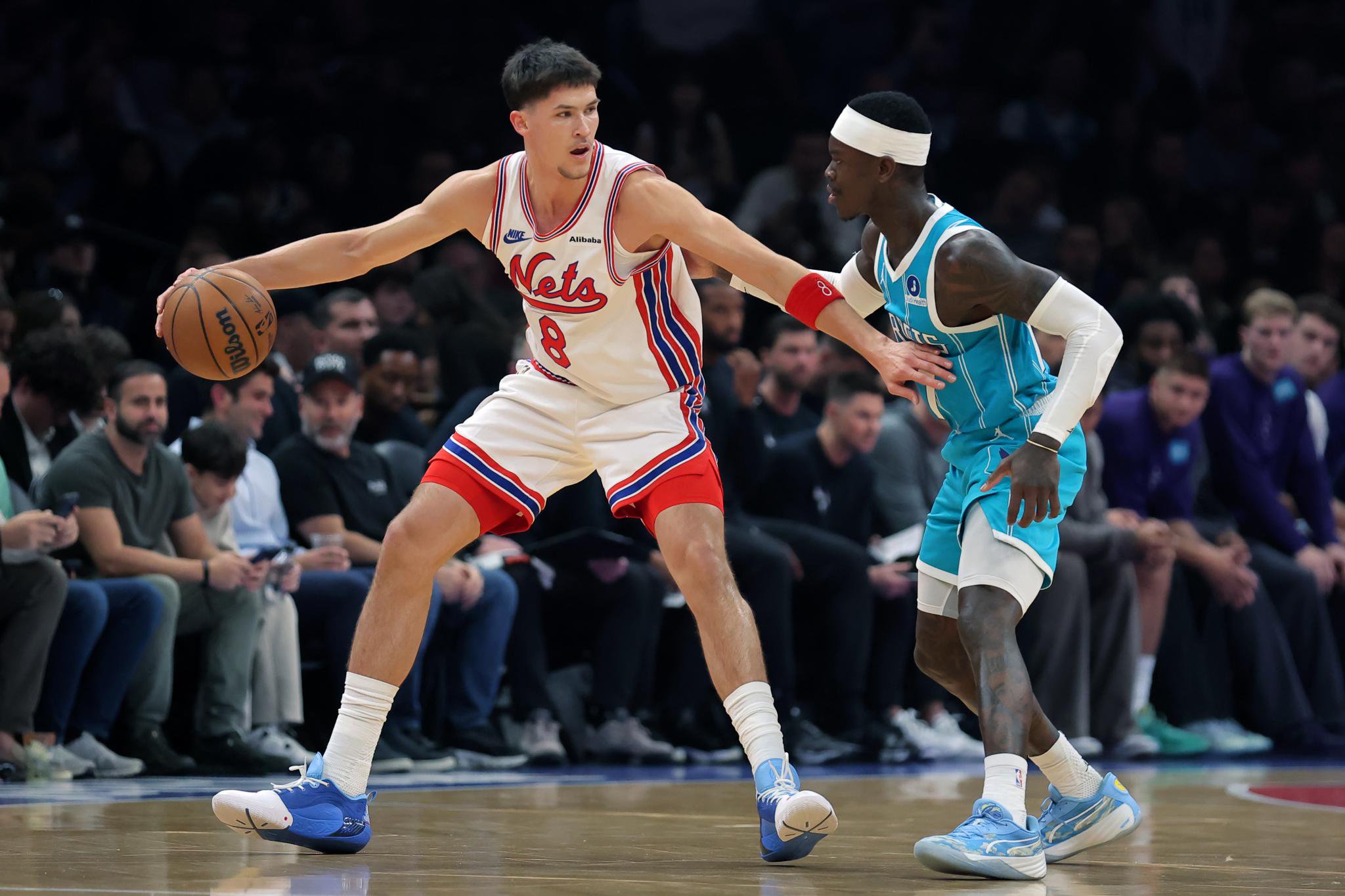Brooklyn Nets guard Egor Demin (8) controls the ball against Charlotte Hornets guard Dennis Schroder (17).