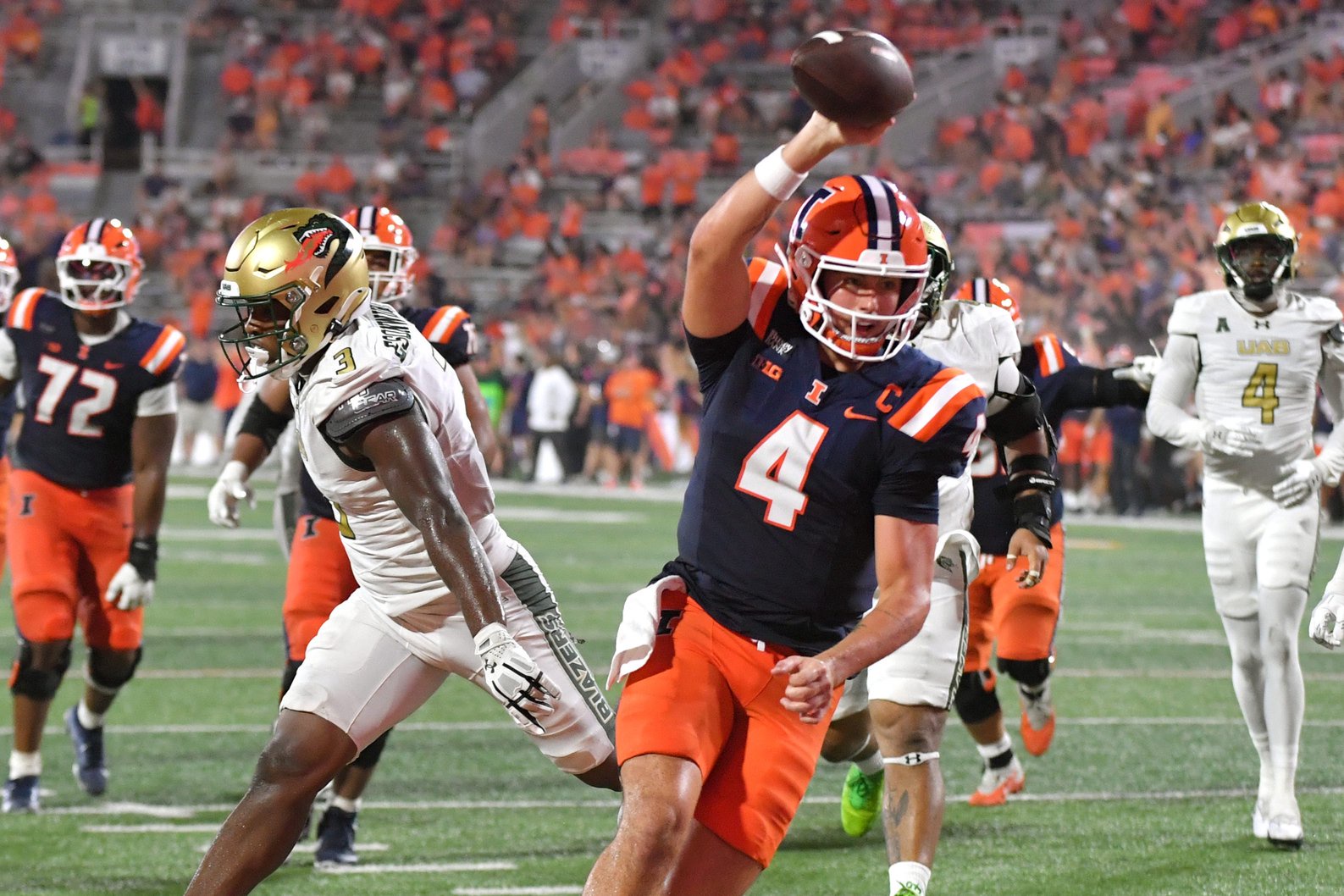 Sep 3, 2026; Champaign, Illinois, USA;  Illinois Fighting Illini quarterback Katin Houser (4) scores a touchdown during the second half against the UAB Blazers at Gies Memorial Stadium.  Mandatory Credit: Ron Johnson-Imagn Images