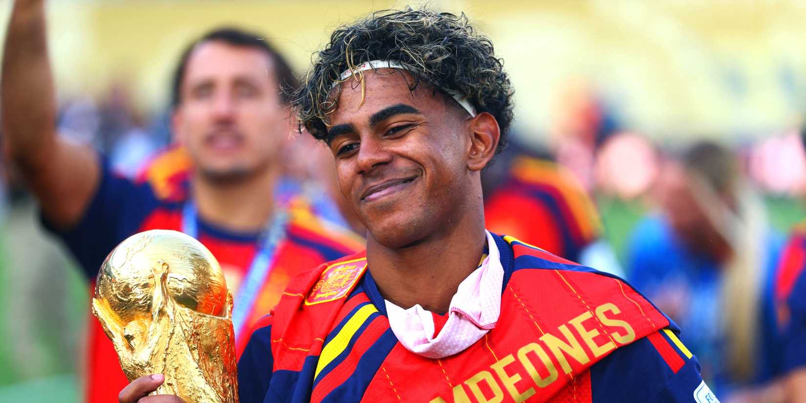 Spain's Lamine Yamal celebrates with the World Cup trophy