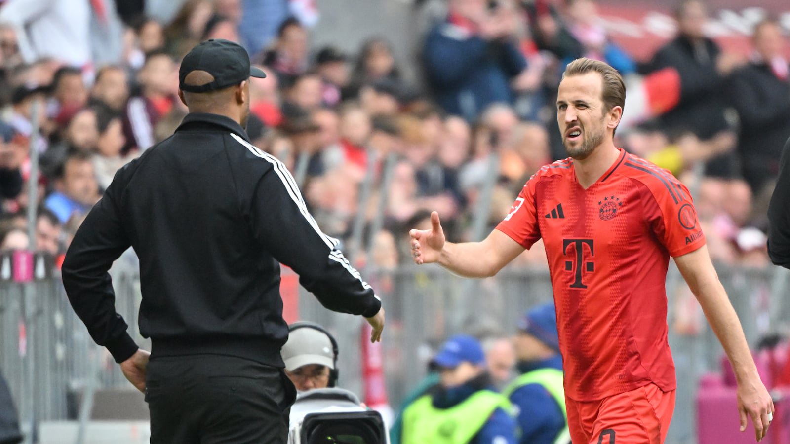 Bayern Munich manager Vincent Kompany (left) and Harry Kane (right) at the Allianz Arena .