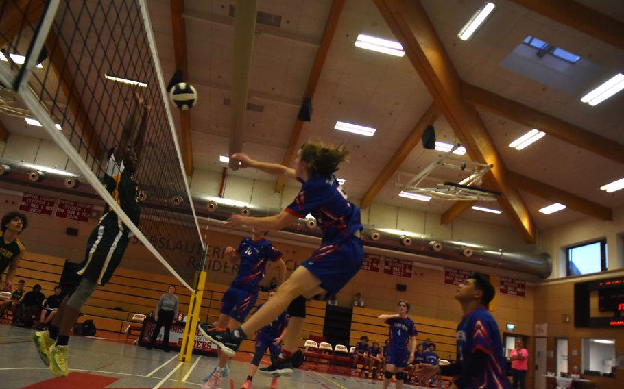 Ramstein’s Quentin Arbour makes a leaping hit against SHAPE on Friday, Oct. 30, 2026, in a semifinal match at Kaiserslautern High School in Germany. SHAPE advanced to the 2026 DODEA European boys’ Division I volleyball match on Saturday to face Stuttgart.