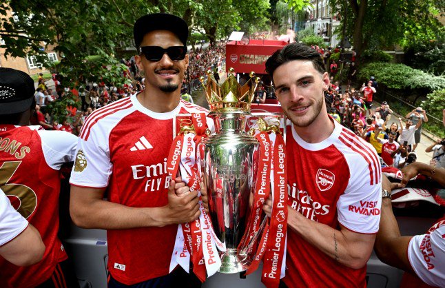 ISLINGTON, ENGLAND - MAY 31: William Saliba and Declan Rice of Arsenal pose for a photo with the Premier League trophy on the open top bus during the Arsenal Trophy Parade on May 31, 2026 in Islington, England. Arsenal clinched their first Premier League title in 22 years earlier this month. (Photo by Stuart MacFarlane/Arsenal FC via Getty Images)