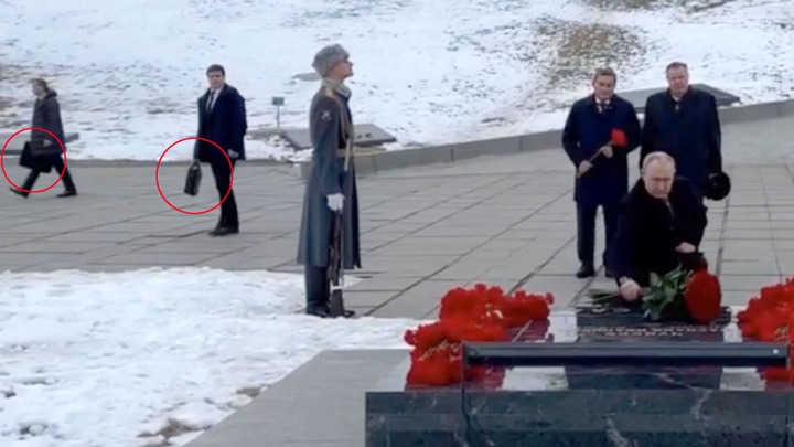 The very important briefcase is constantly surrounded by officers the Kremlin trusts and follows