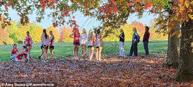 The girls walked past the starting line with their arms linked and into the nearby tree line