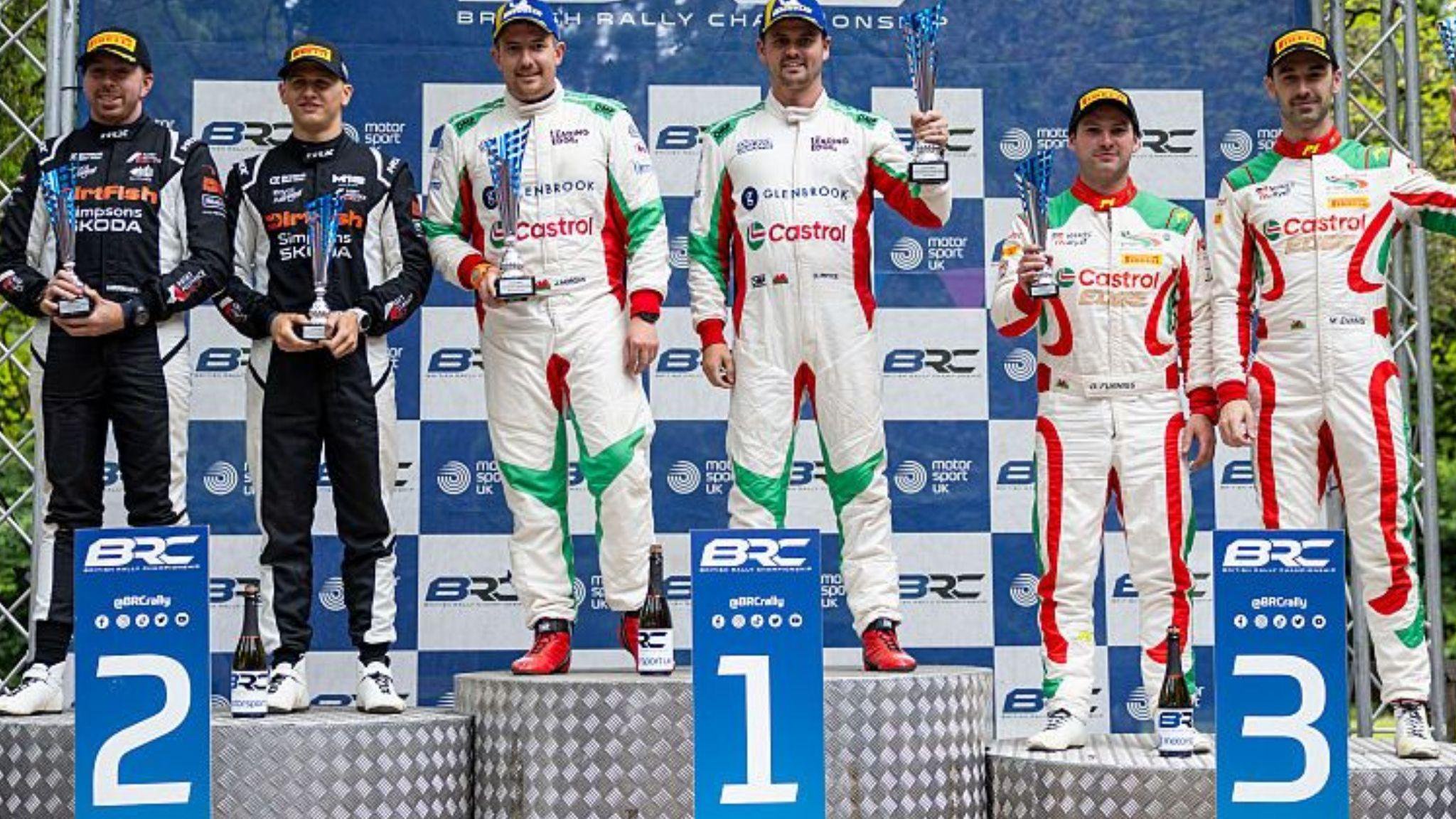 Osian Pryce and James Morgan stood on the first place podium with a trophy. Max Mcrae and co-driver Cameron Fair on the second place podium with trophies and Meirion Evans and Dale Furniss on the third place podium with trophies.