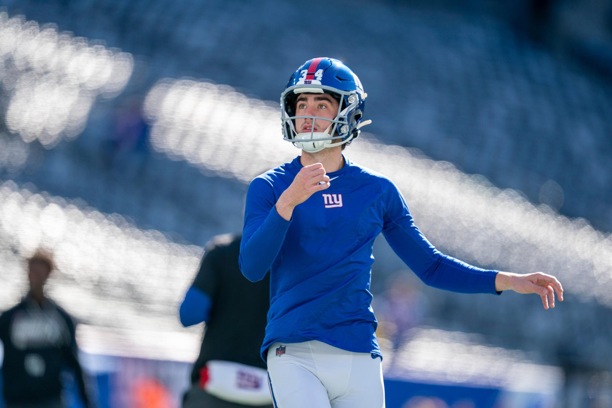 New York Giants kicker Dominic Zvada warms up on the field.