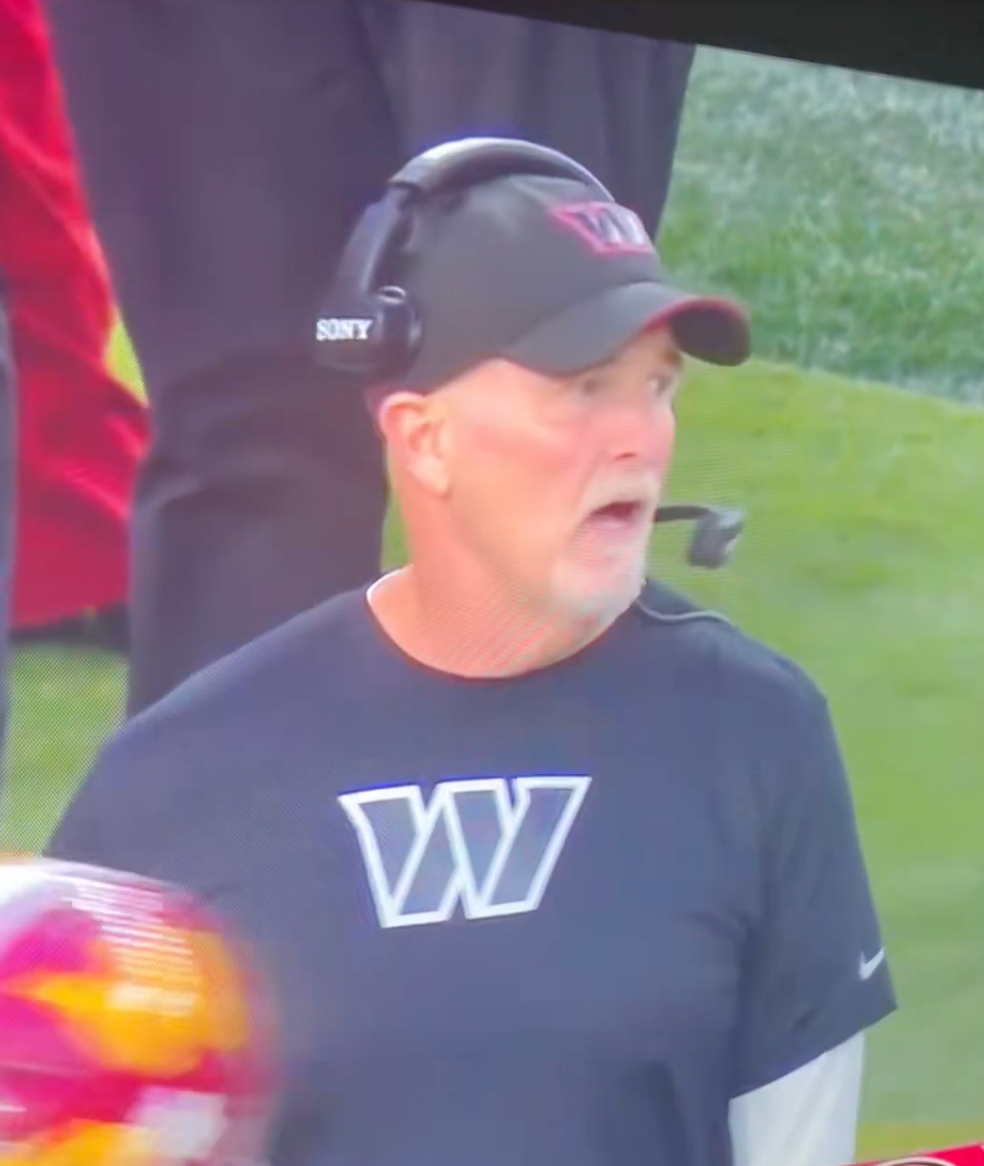Washington Commanders head coach Dan Quinn shouting on the sideline.