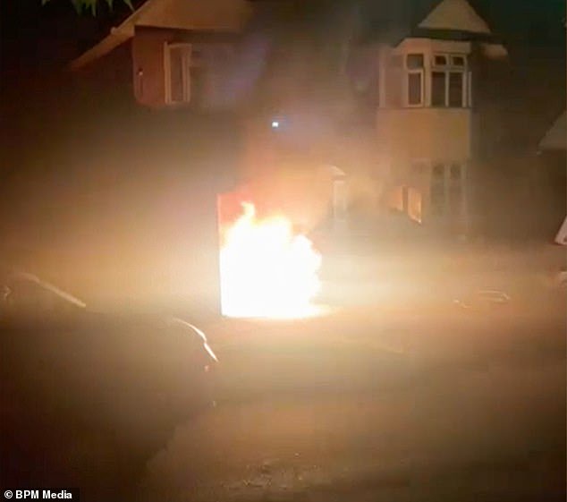 Moment two men pour petrol over car at family home of a politician and then set it ablaze (Video)