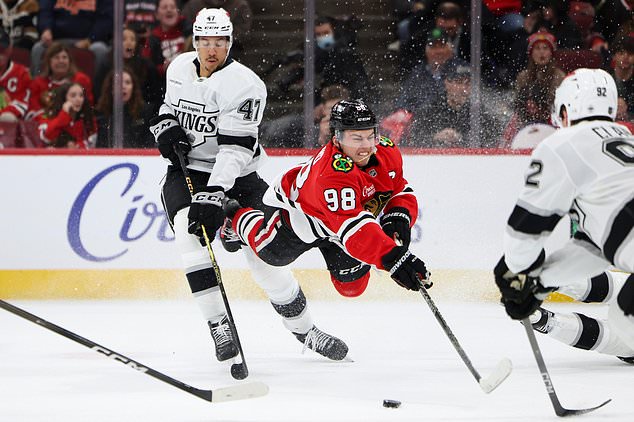 Chicago Blackhawks center Connor Bedard (98) attempts to shoot against Los Angeles Kings left wing Andre Lee (47) during the second period of an NHL hockey game, Tuesday, Oct. 27, 2026, in Chicago. (AP Photo/Jessie Alcheh)