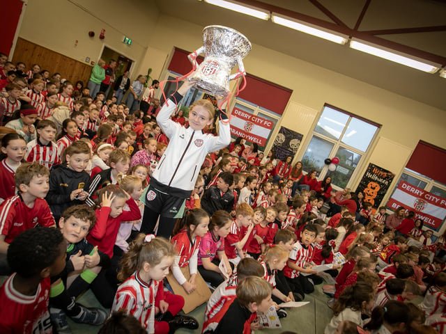 UP WITH THE CUP!. . .  Hollybush PS pupil Mia shows her support for Derry City on Friday. (Photos: Jim McCafferty Photography)