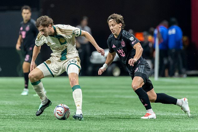 Atlanta United midfielder Alexey Miranchuk, left, and Inter Miami midfielder Matías Galarza, right, battle during the first half of an MLS soccer match Saturday, Oct. 17, 2026, in Atlanta. (AP Photo/Vasha Hunt)