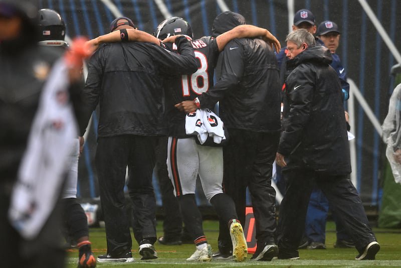 Sep 20, 2026; Chicago, Illinois, USA;  Chicago Bears quarterback Caleb Williams (18) is helped off the field with an apparent injury against the Minnesota Vikings during the second half at Soldier Field.  Mandatory Credit: Patrick Gorski-Imagn Images