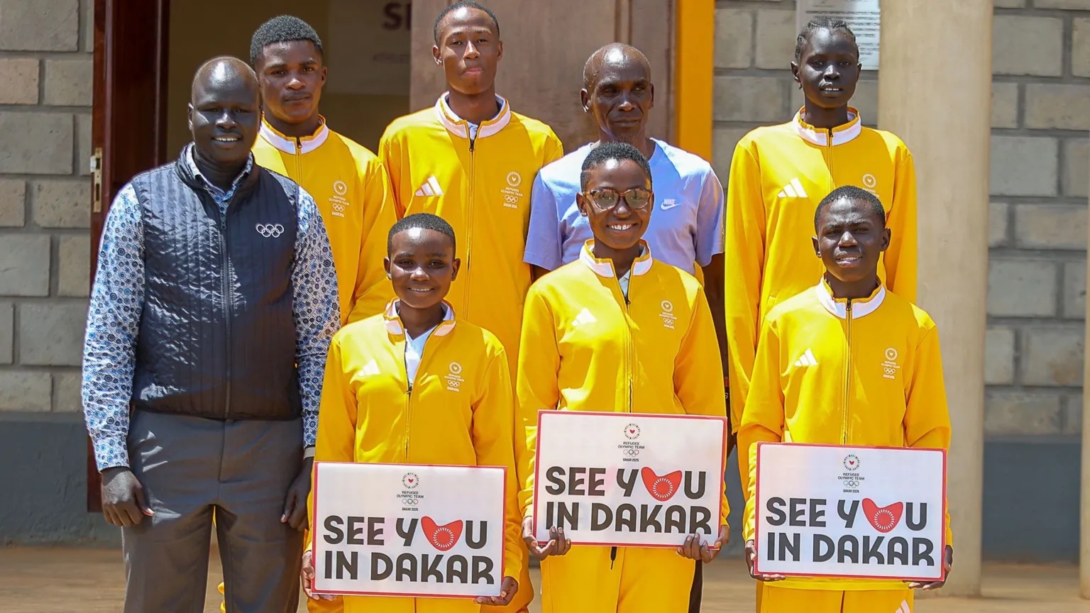 Getty Images Yiech Pur Biel, Chef de Mission, (L), Arno (2nd Row L-R), Rachid, Eliud Kipchoge, Nyataba, Florence (first row L-R), Laurence and Clement pose during a training camp of the IOC Refugee Olympic Team for the Dakar 2026 Youth Olympic Games on September 9, 2026 in Kaptagat, Kenya. 