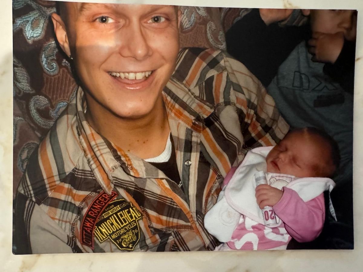 Paul Hunter holding his baby daughter Evie, who was just 10 months old when he died of cancer 