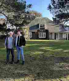 Tom Glanfield (pictured right) standing in the rear of the property in Sandbanks, Dorset, which is part of a 1.4 acre plot with a huge garden providing uninterrupted views across Poole Harbour