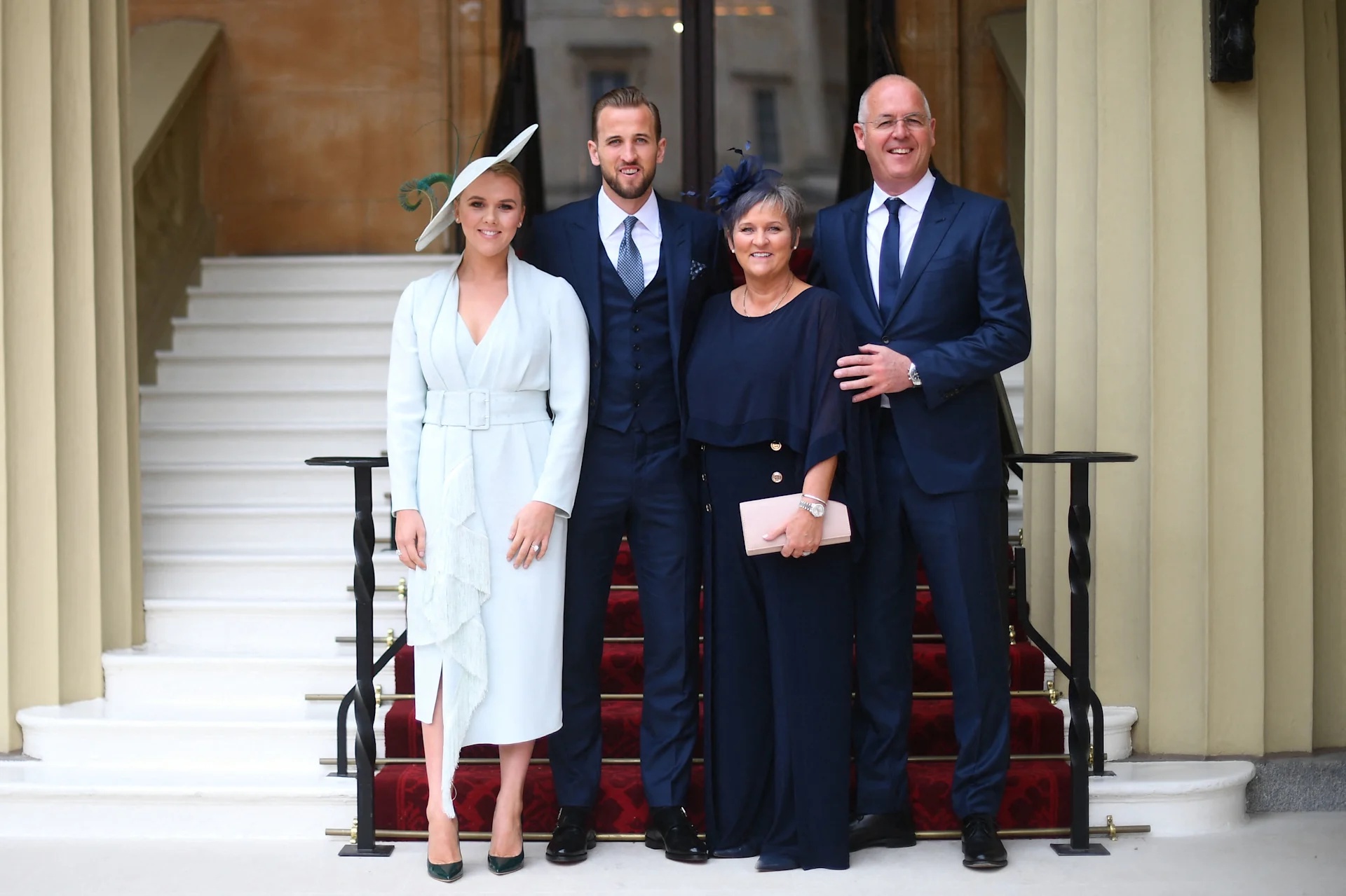 LONDON, ENGLAND - MARCH 28: England football captain and Tottenham Hotspur player Harry Kane with (left to right) his partner Kate Goodland and parents Kim and Patrick Kane arrive for his investiture ceremony at Buckingham Palace on March 28, 2019 in…