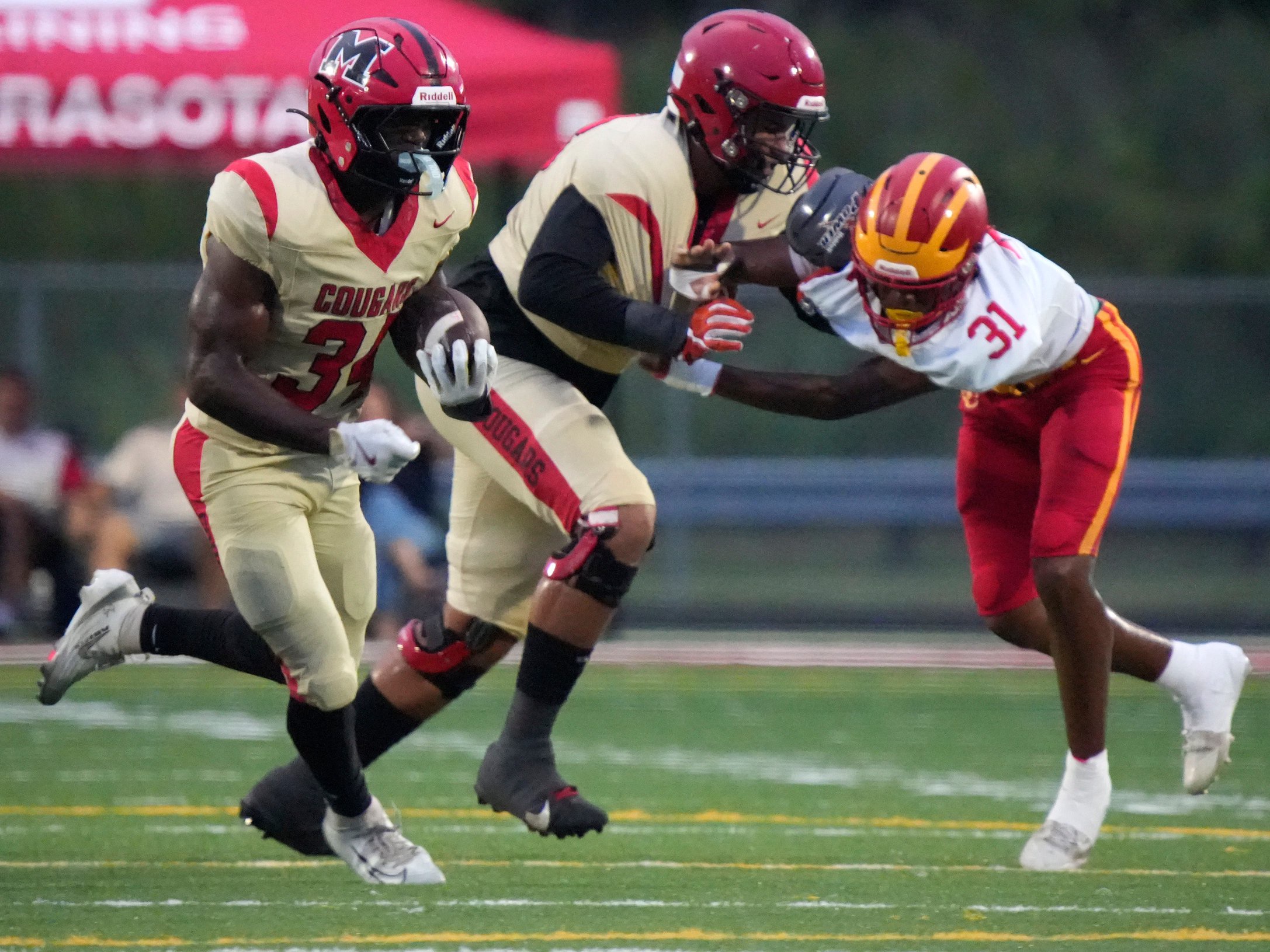 Cardinal Mooney running back Connail Jackson (#34) follows his blocker, Jackson Snelling (#68), who takes Clearwater Central Catholic defensive end Cerrious Wynn (#31) out of the play. Jackson scored on the play. Cardinal Mooney Catholic High School hosted Clearwater Central Catholic High School in varsity football Friday evening, Oct. 2, 2026.