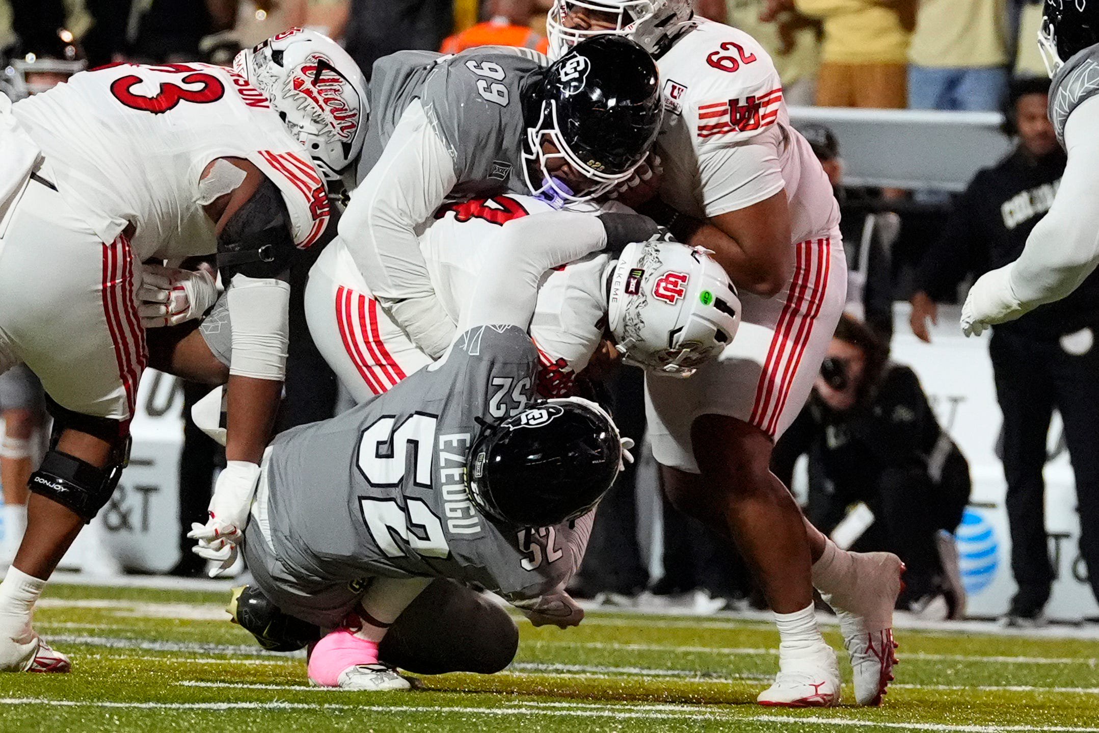 Oct 17, 2026; Boulder, Colorado, USA;  Utah Utes quarterback Devon Dampier (4) is sacked by Colorado Buffaloes defensive lineman Dylan Manuel (99) and defensive end Manny Ezeogu (52) in the second half at Folsom Field.  Mandatory Credit: Ron Chenoy-Imagn Images
