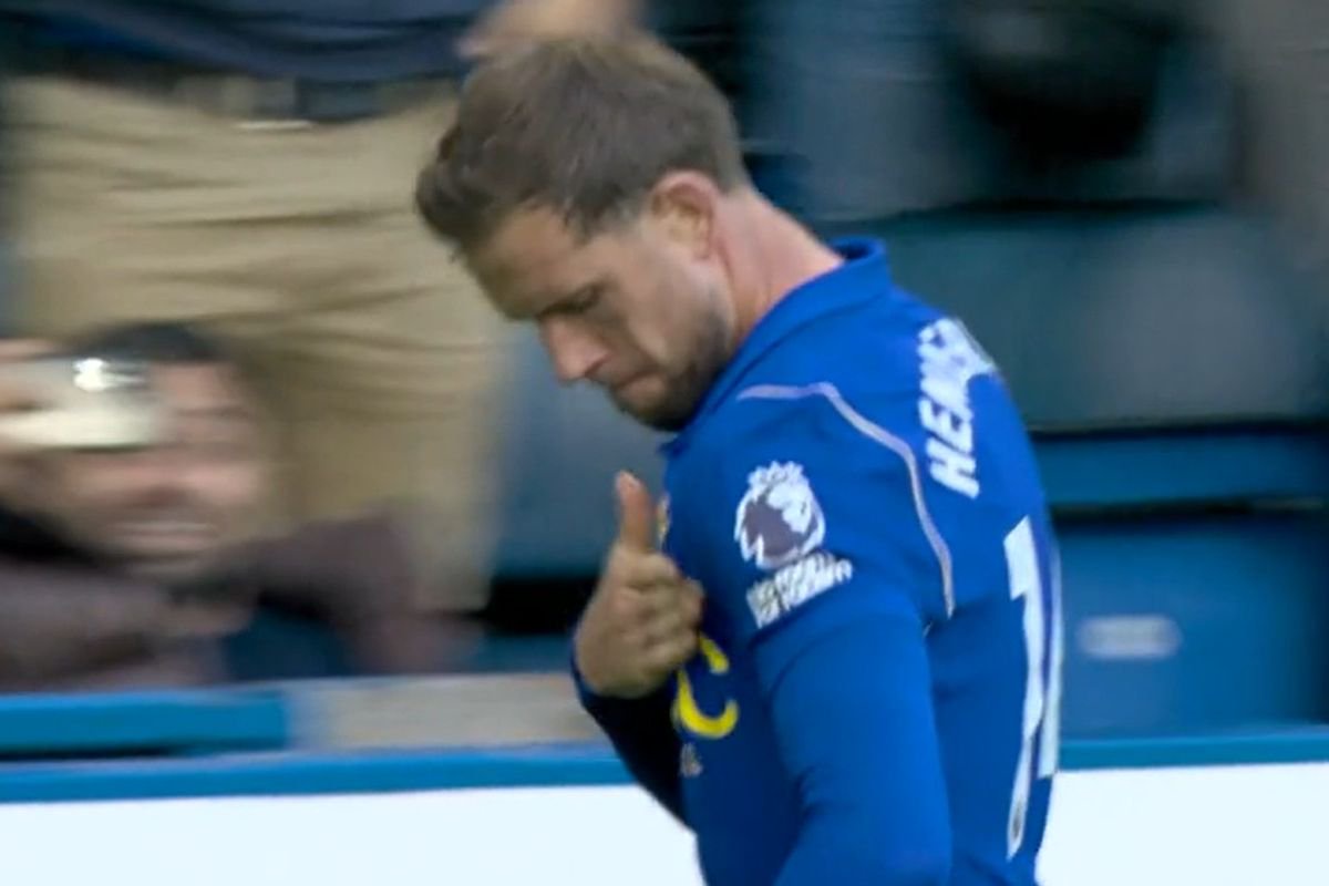 Jordan Henderson taps the Chelsea badge after scoring against Bournemouth