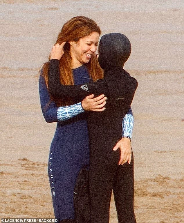 All smiles: The Colombian singer, 45, showed off her incredible figure in the fitted navy wetsuit with blue patterned cuffs as she enjoyed a day out surfing