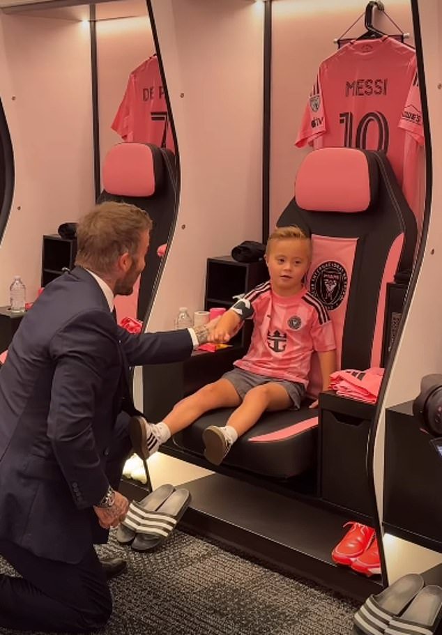 Magical moment: David then held Huddy's hand to show him around the locker room, where he got the chance to sit on Lionel Messi's chair